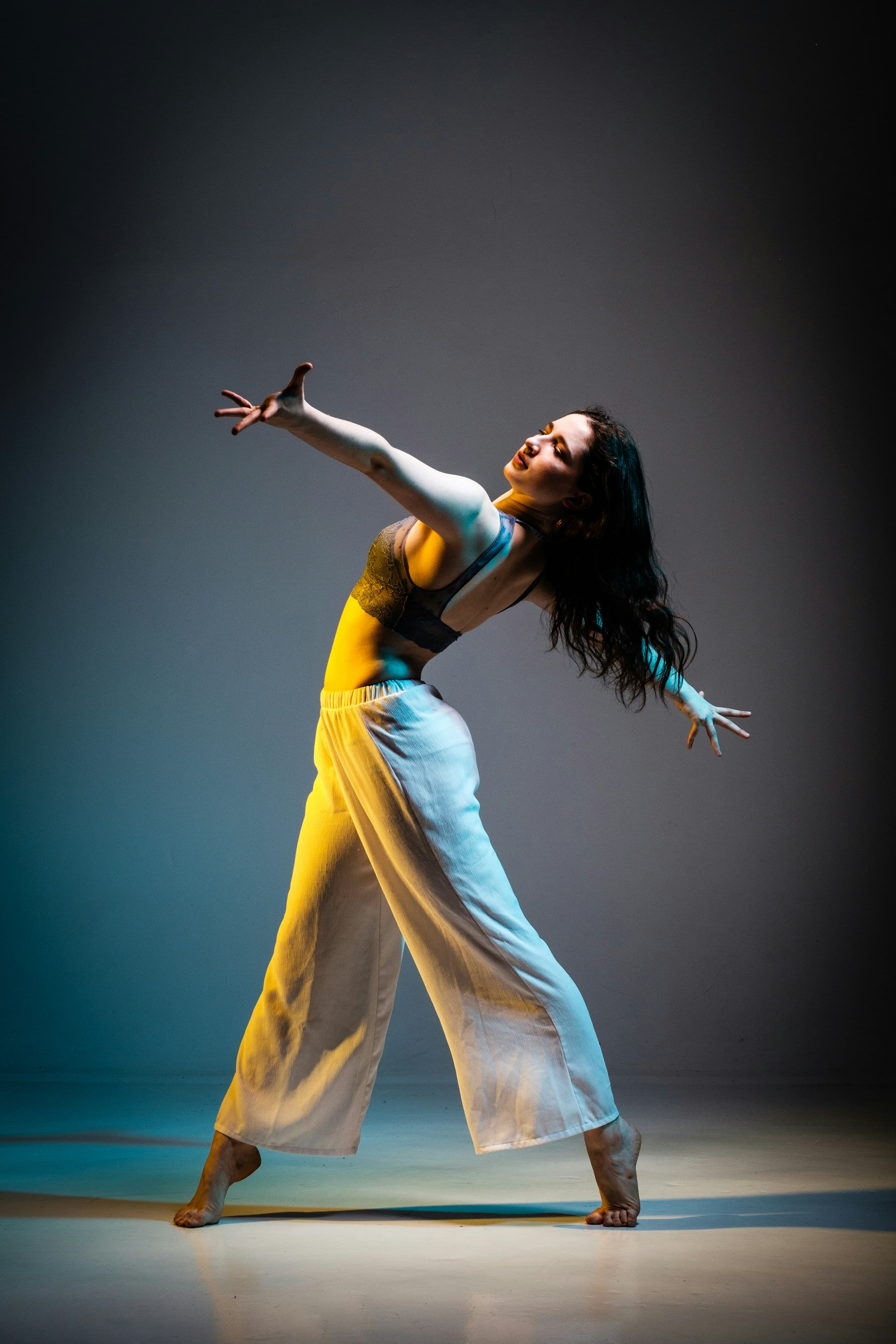 A dancer exploring movement in a photographic studio